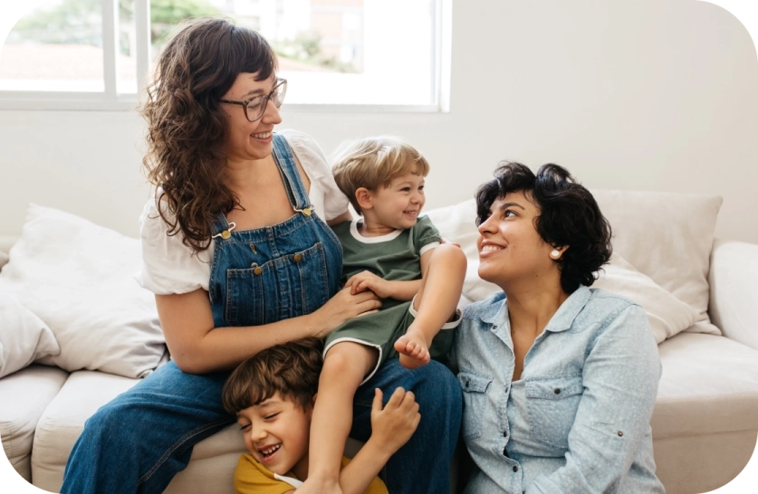 Mom, Dad and two kids playing together in the living room